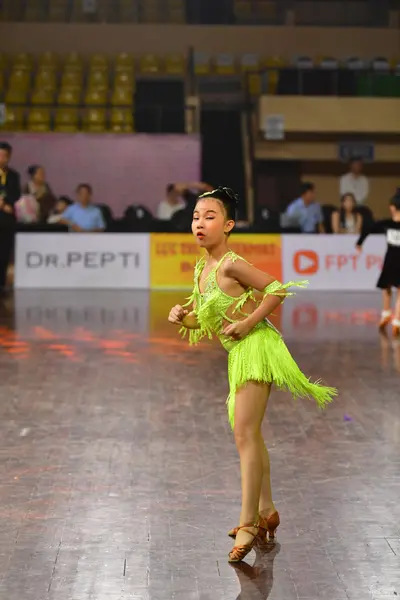 Dancesport competitor: Female dancer: lime green latin dress with fringe