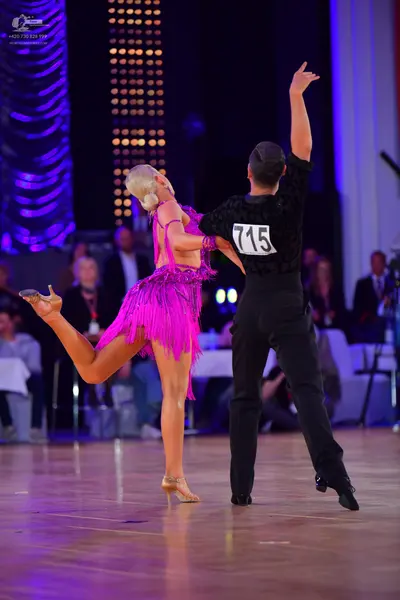 Dancesport competitor #715: Male dancer: black long-sleeved shirt and black trousers