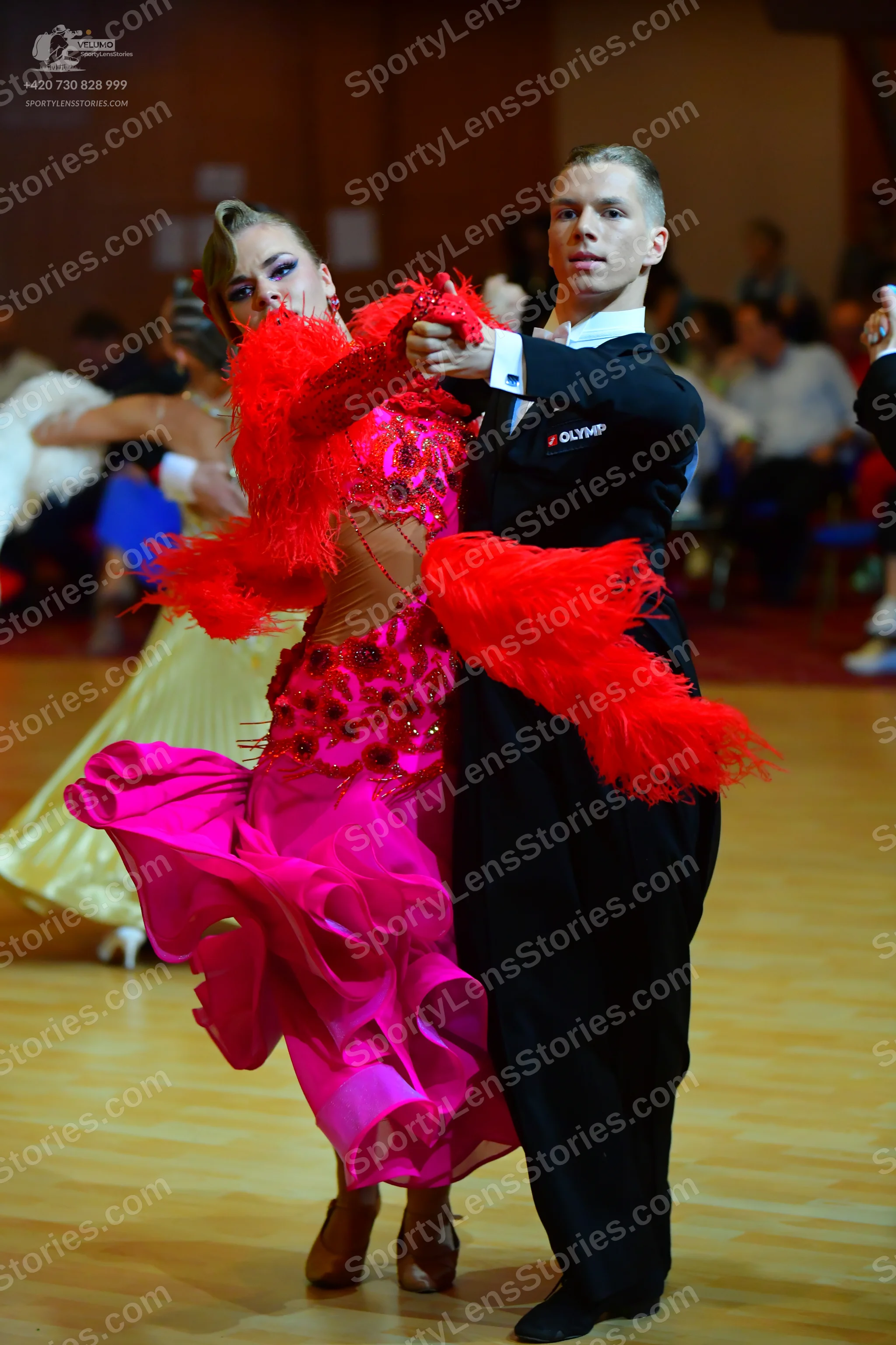 Dancesport competitor: Male dancer: black suit with a small white logo on the sleeve