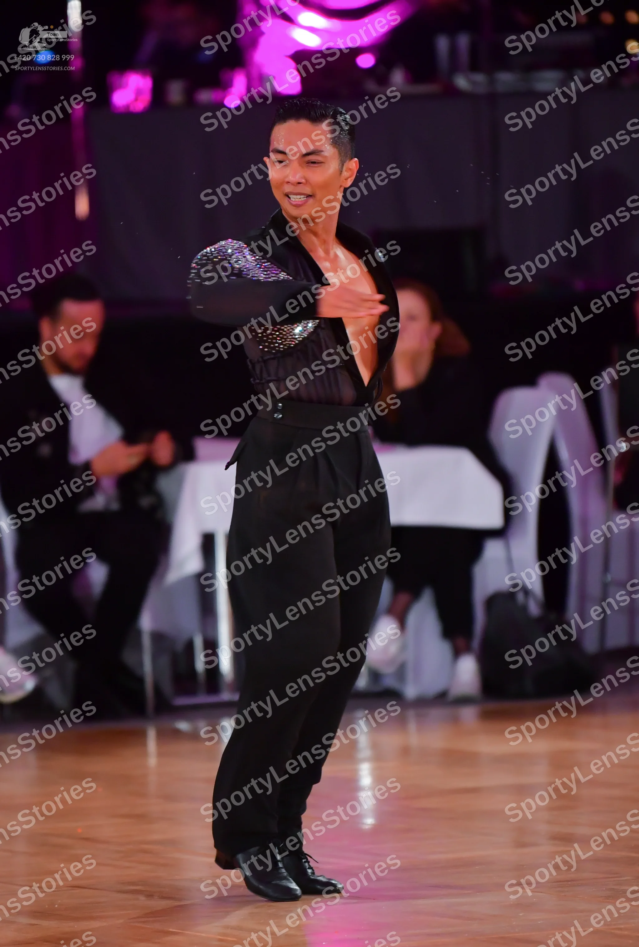 Dancesport competitor: Male dancer: black long-sleeved Latin dance shirt with silver sequins on the sle
