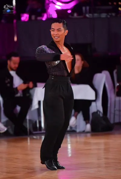 Dancesport competitor: Male dancer: black long-sleeved Latin dance shirt with silver sequins on the sle