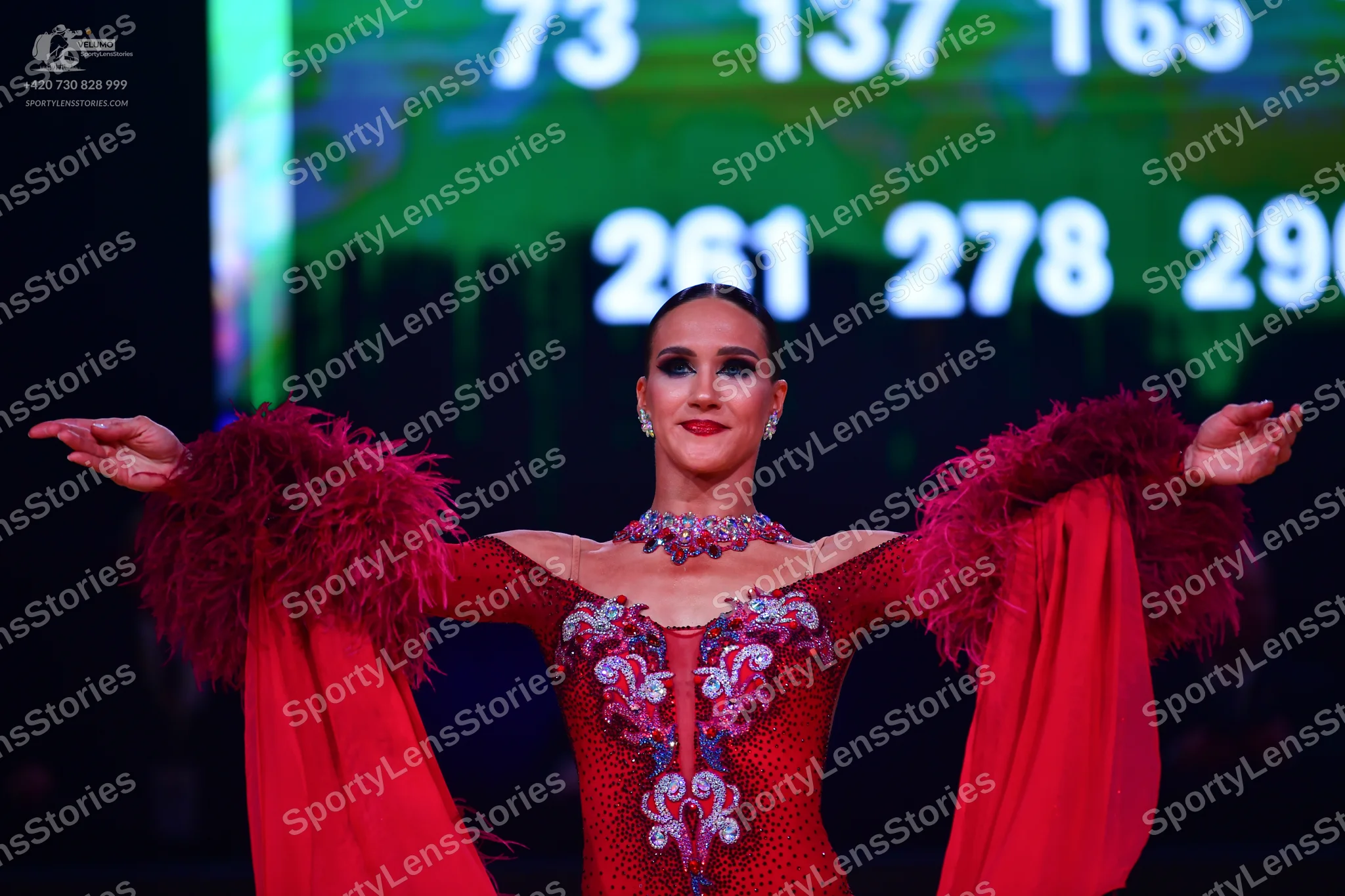 Dancesport competitor: Female dancer: red Latin dress with silver/white sequined/embellished bodice and