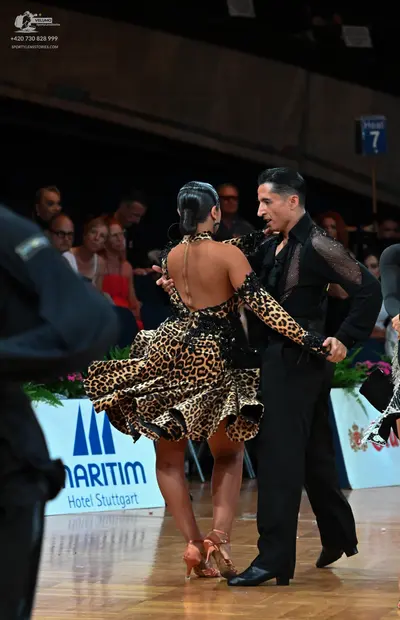 Dancesport competitor: Female dancer: leopard print latin dress with long sleeves and backless design