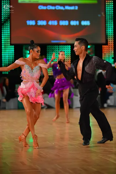 Dancesport competitor: Female dancer: pink Latin dance dress with a sequined/beaded bodice and a ruffle