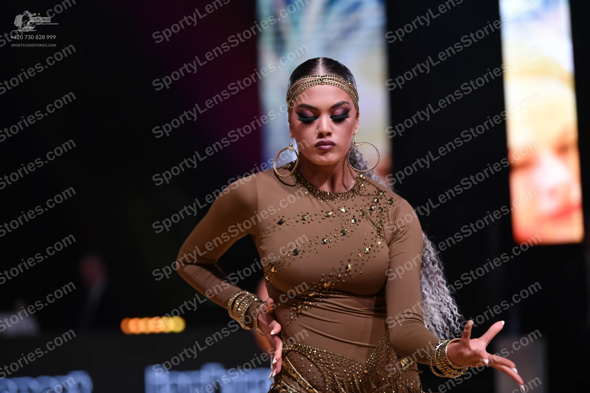Dancesport competitor: Female dancer: tan long-sleeved latin dance dress with small sequin embellishmen