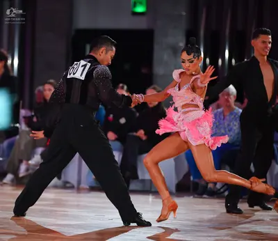Dancesport competitor #601: Male dancer: black shirt with silver sequins on the back/shoulders, black trouse