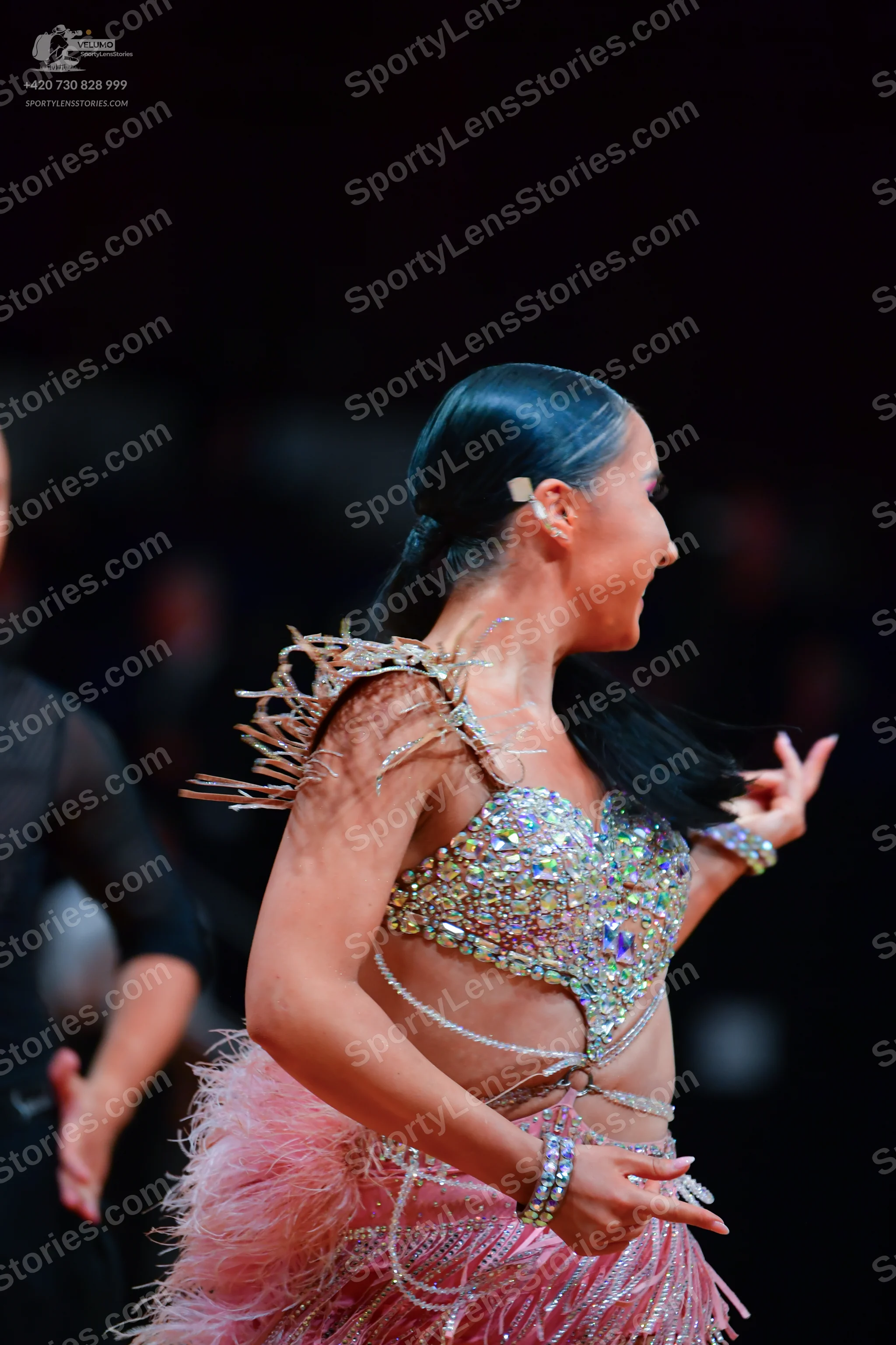 Dancesport competitor: Female dancer: pink latin dance dress, heavily embellished with sequins and rhin