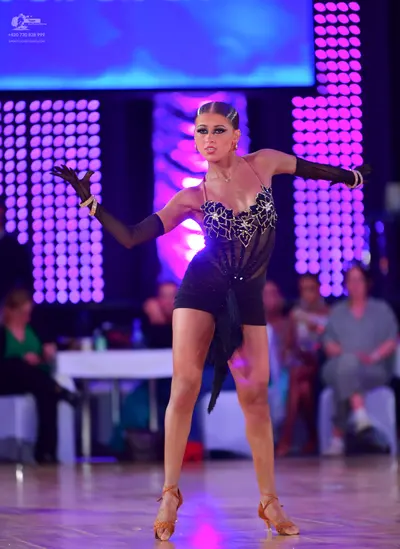 Dancesport competitor: Female dancer: black latin dress with silver sequin patterns on the bodice, long