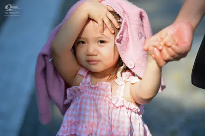 Dancesport competitor: Female dancer: pink and white gingham ruffled dress with a pink knit cardigan