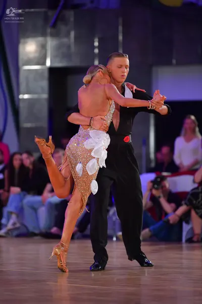 Dancesport competitor: Male dancer: black long-sleeved shirt and black trousers