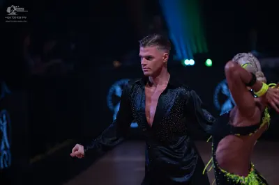 Dancesport competitor: Male dancer: black long-sleeved shirt with a subtle sparkle