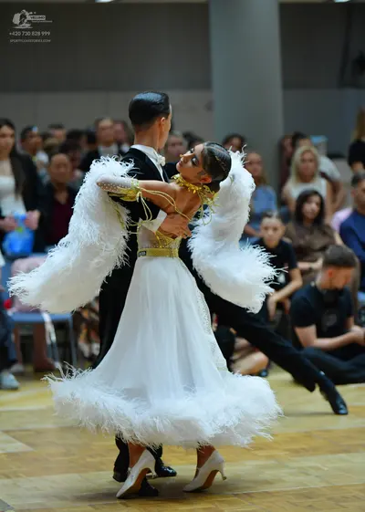 Dancesport competitor: Male dancer: black suit with a white shirt and black trousers