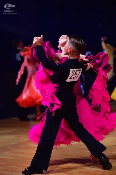 Dancesport competitor: Male dancer: black long-sleeved top and black trousers