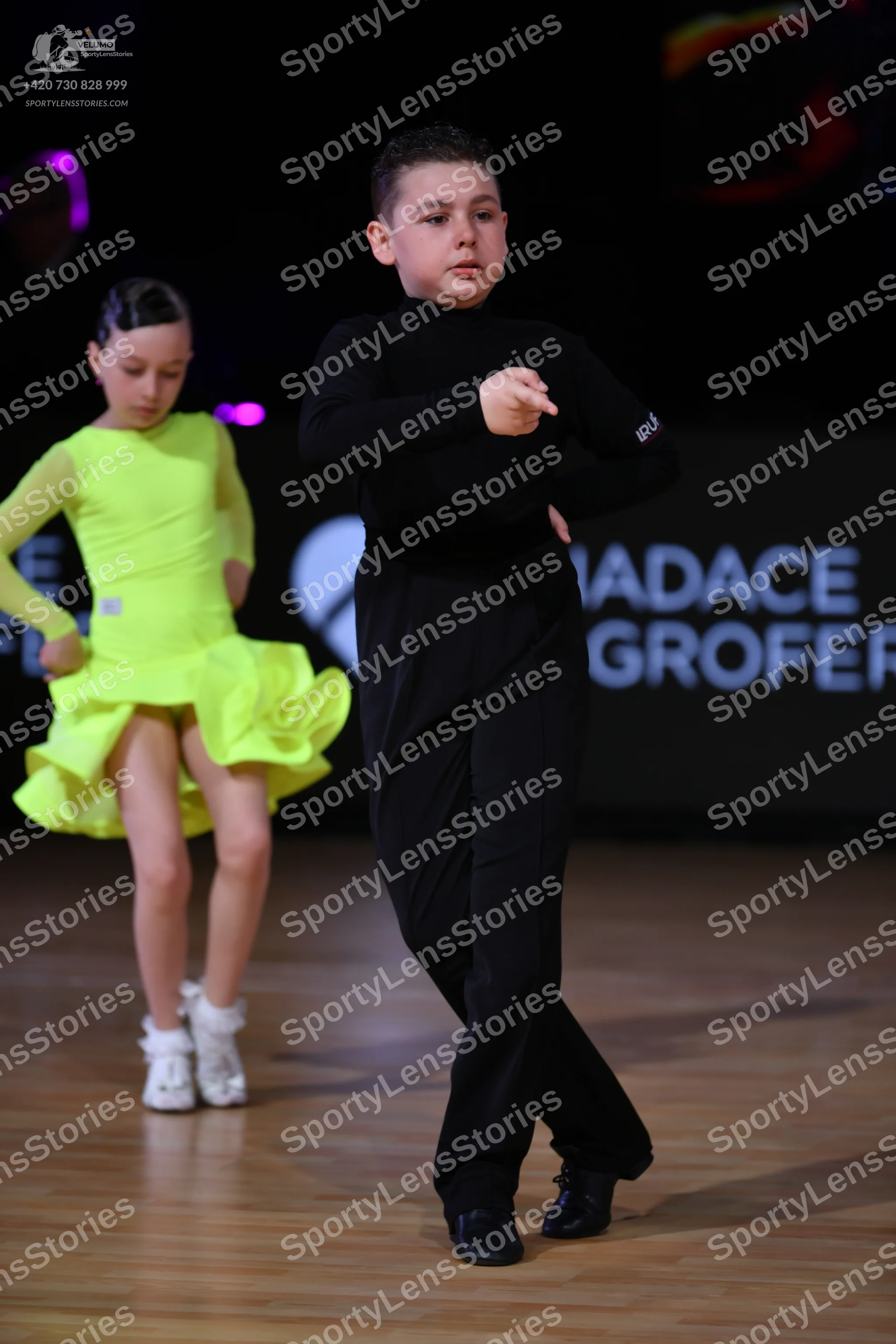 Dancesport competitor: Male dancer: black long-sleeved top and black trousers