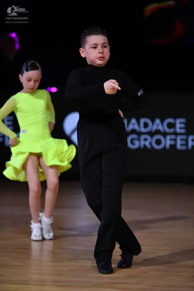 Dancesport competitor: Male dancer: black long-sleeved top and black trousers