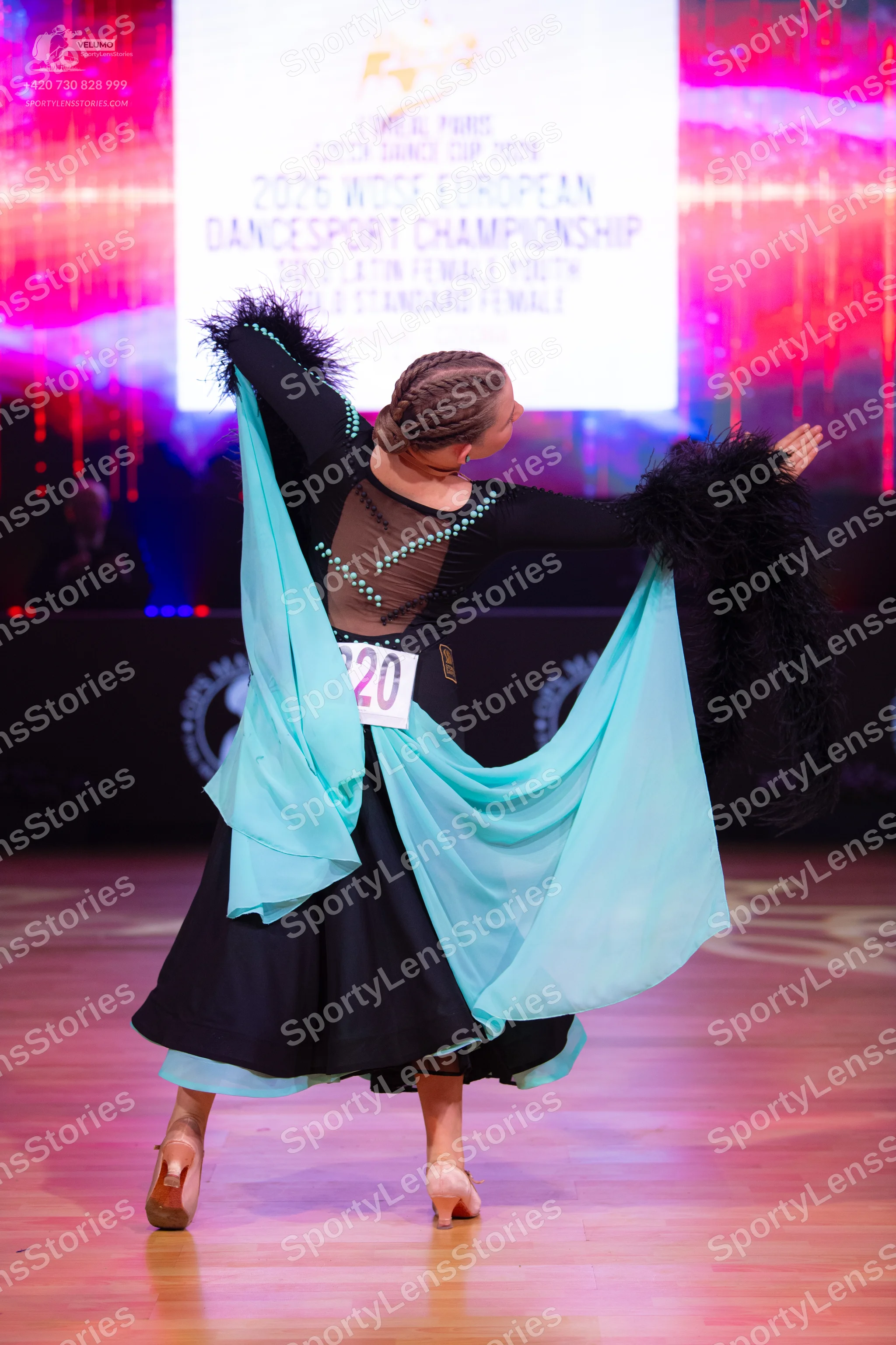 Dancesport competitor: Female dancer: black ballroom dress with a tan mesh back panel decorated with si