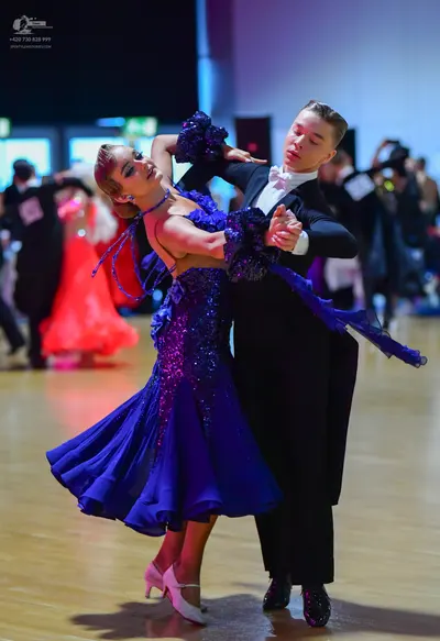 Dancesport competitor: Male dancer: black suit, white shirt, and white bowtie