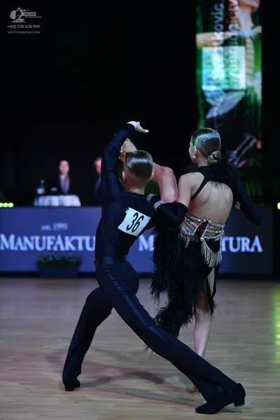 Dancesport competitor: Male dancer: black long-sleeved shirt and black trousers