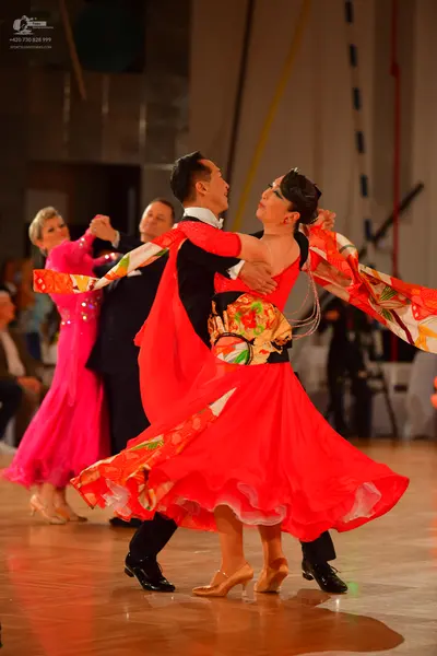 Dancesport competitor: Female dancer: pink ballroom gown with sequin embellishments