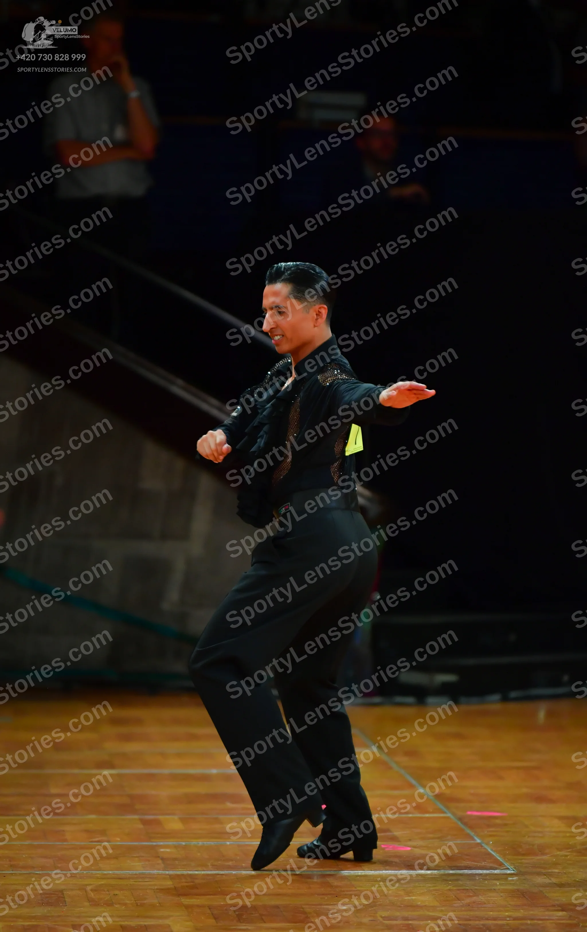 Dancesport competitor: Male dancer: black long-sleeved shirt with sequin or metallic embellishments on 