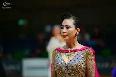Dancesport competitor: Female dancer: champagne-colored dress with heavy sequin and rhinestone embellis