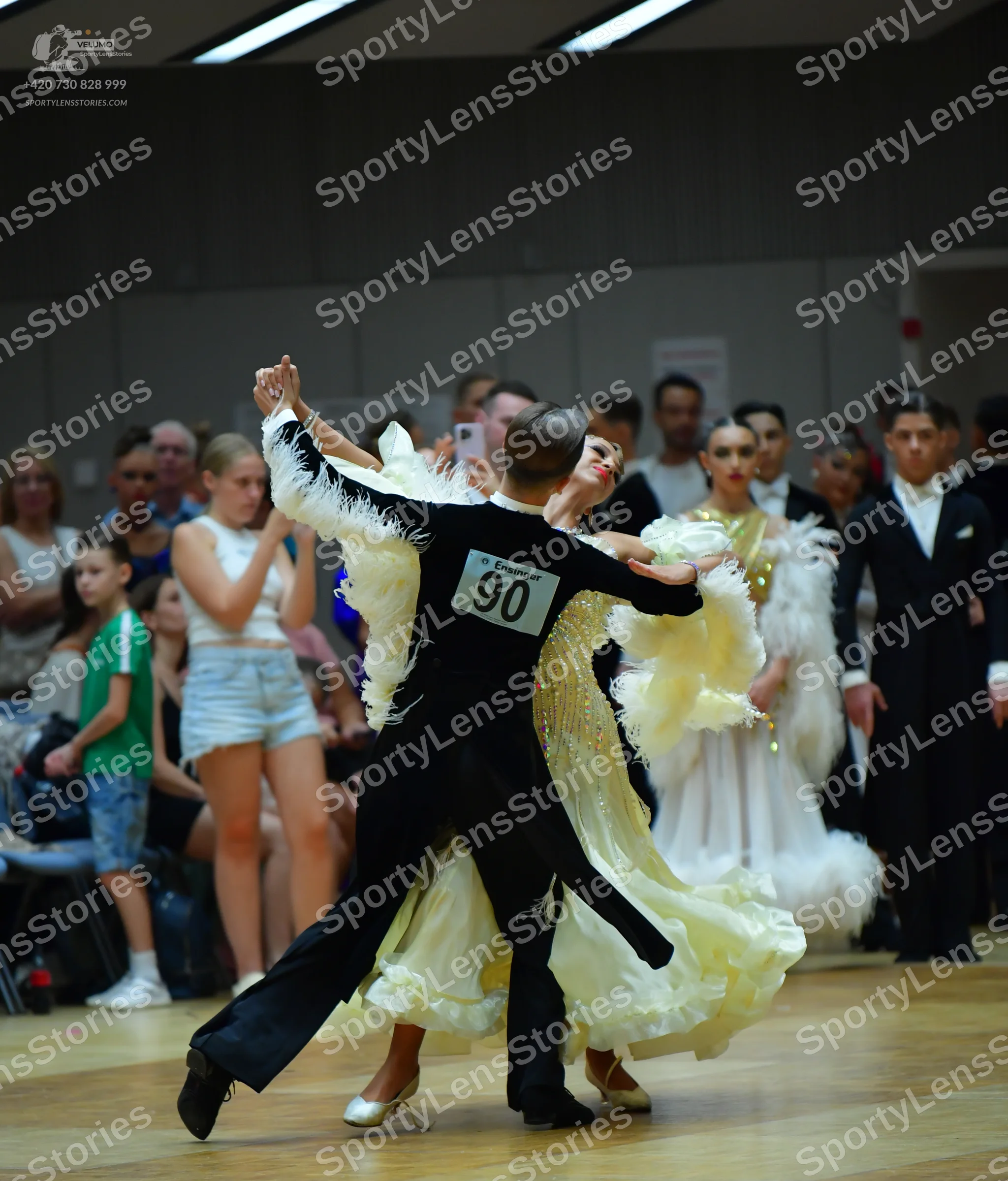 Dancesport competitor #90: Male dancer (foreground): black suit and trousers