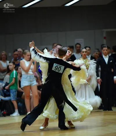 Dancesport competitor #90: Male dancer (foreground): black suit and trousers