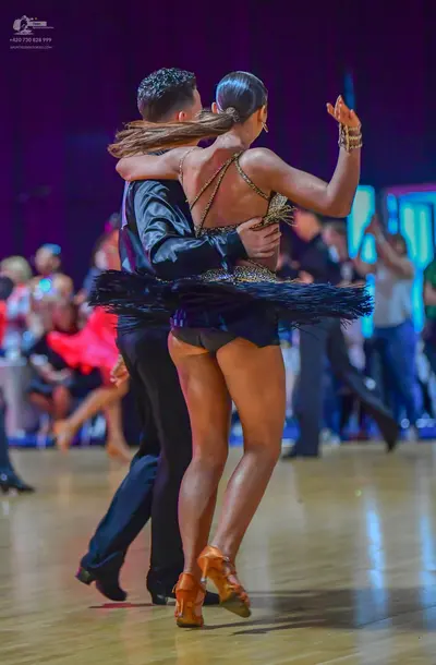Dancesport competitor: Male dancer: black long-sleeved shirt and black trousers