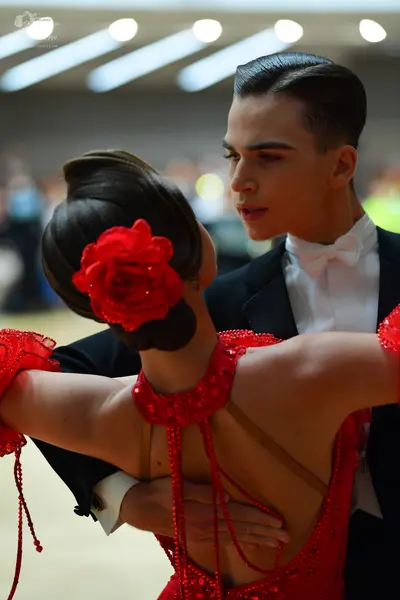 Dancesport competitor: Male dancer: black suit, white shirt, and white bowtie