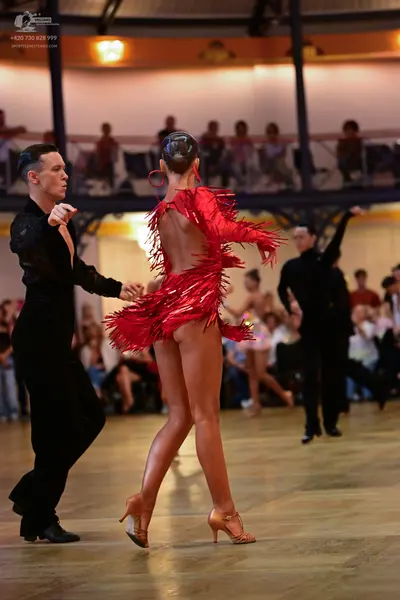 Dancesport competitor: Male dancer: black long-sleeved shirt and black trousers