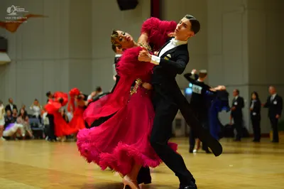 Dancesport competitor: Male dancer: black tuxedo with a white shirt and black bow tie
