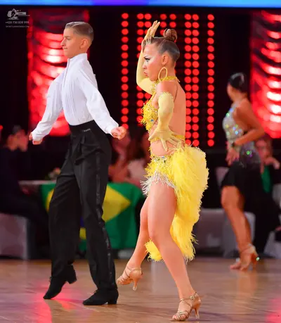 Dancesport competitor: Male dancer: white long-sleeved shirt and black trousers