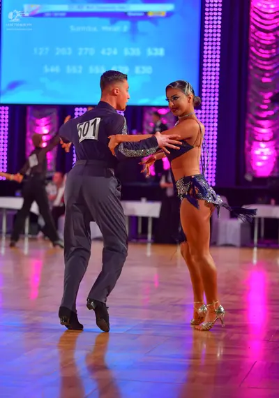 Dancesport competitor #501: Male dancer: dark navy or black long-sleeved shirt and dark grey trousers with b