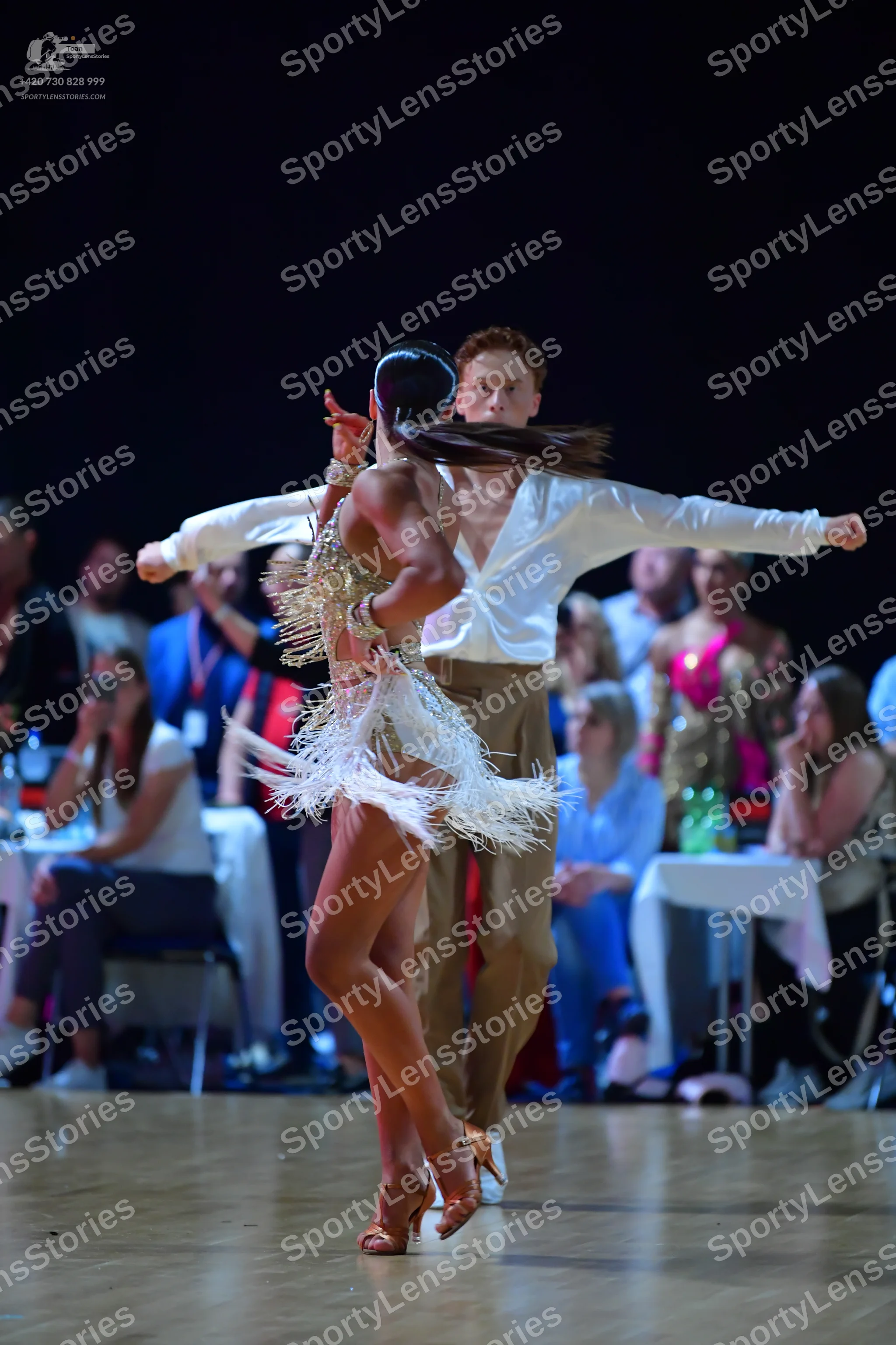 Dancesport competitor: Male dancer: white long-sleeved shirt and tan trousers