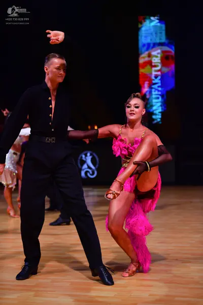 Dancesport competitor: Male dancer: black long-sleeved shirt and black trousers