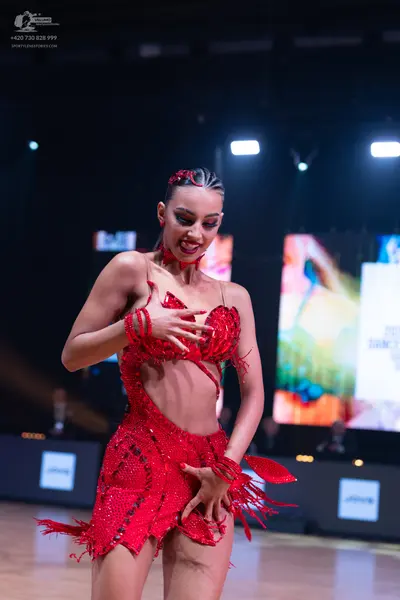Dancesport competitor: Female dancer: red latin dress with sequins and fringe