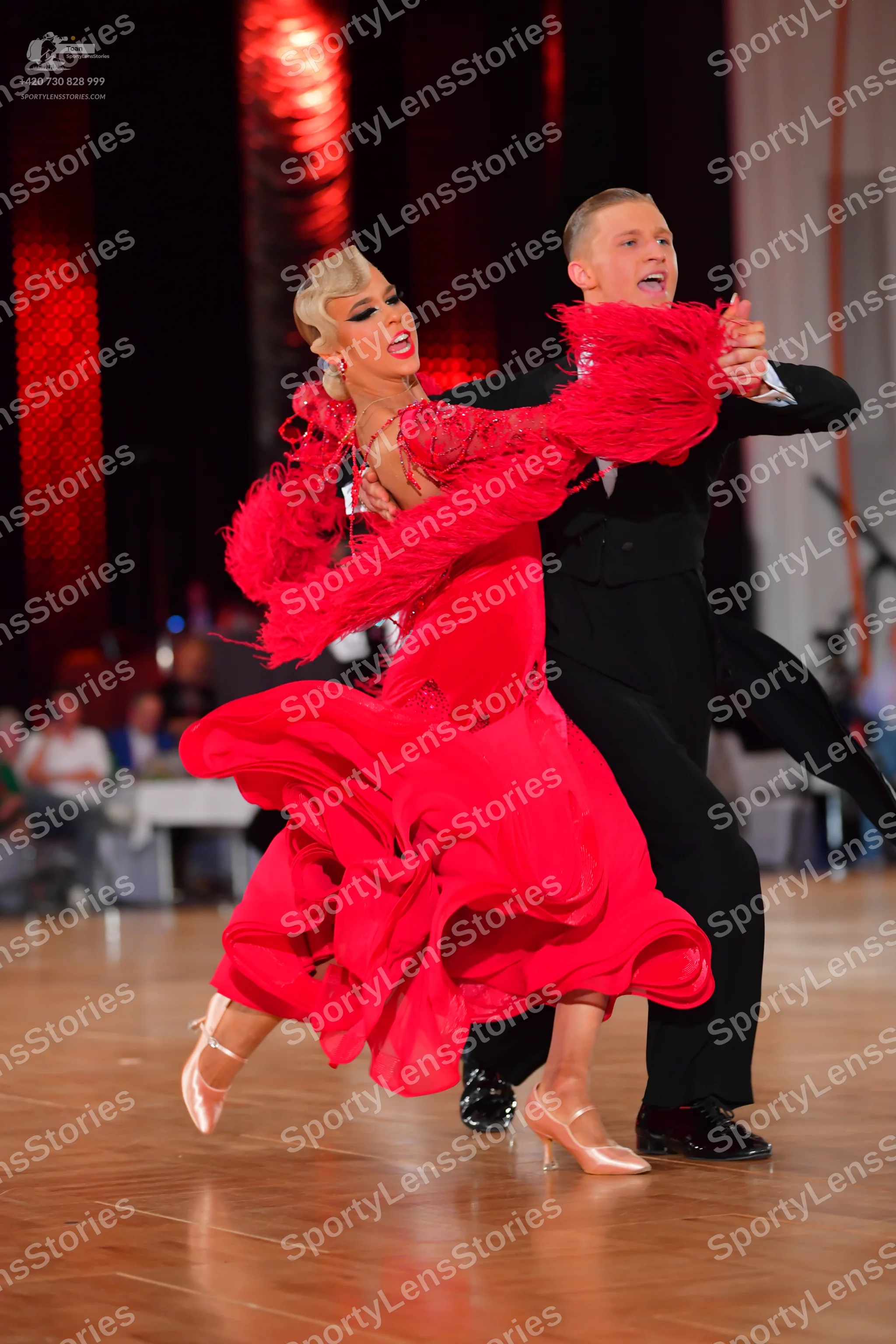 Dancesport competitor: Female dancer: red latin dress with voluminous flowing skirt and textured/fringe