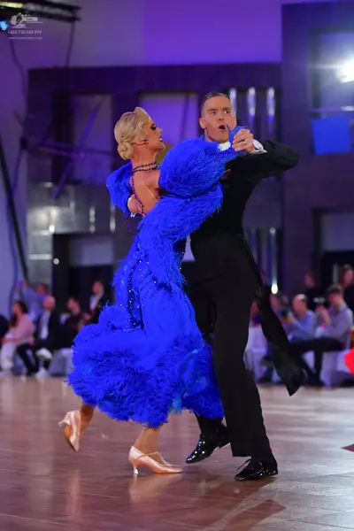 Dancesport competitor: Female dancer: royal blue feathered latin dress