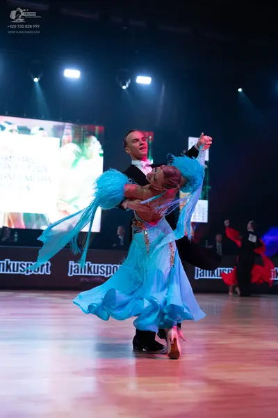 Dancesport competitor: Male dancer: black suit with a white shirt and white bow tie