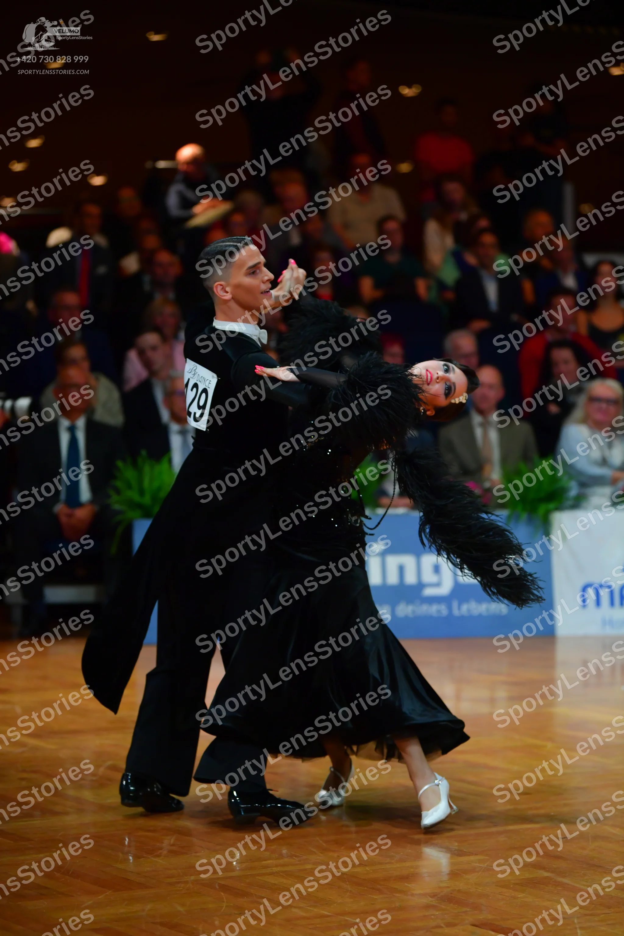 Dancesport competitor #129: Male dancer: black tailcoat, black trousers, and black shoes