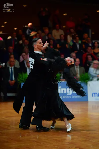 Dancesport competitor #129: Male dancer: black tailcoat, black trousers, and black shoes