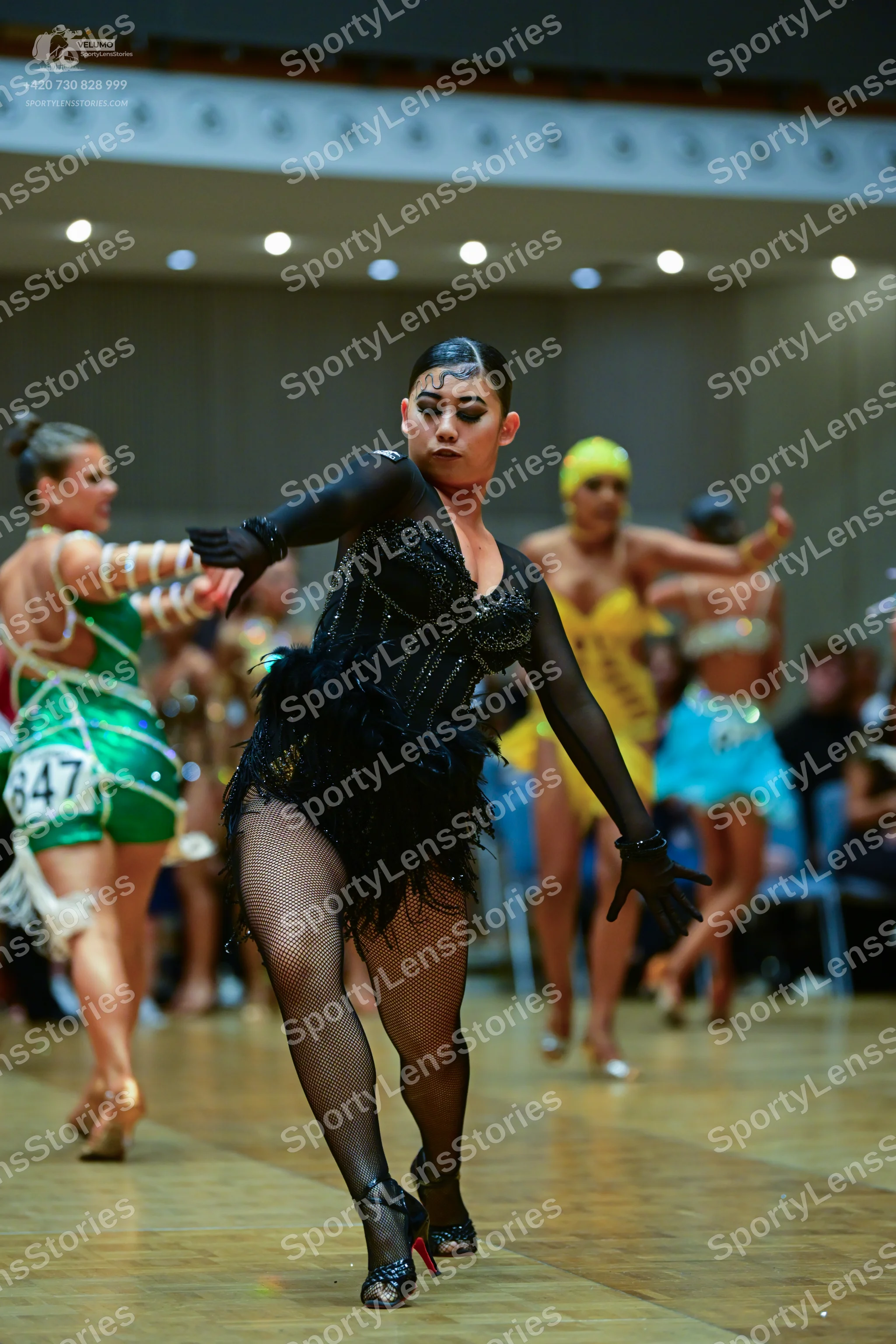 Dancesport competitor #847: Female dancer 1: green latin dress with white accents