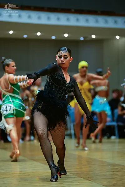 Dancesport competitor #847: Female dancer 1: green latin dress with white accents