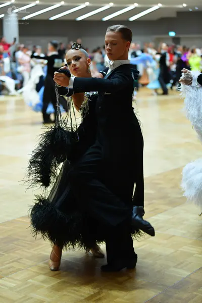 Dancesport competitor: Male dancer: black suit with a white shirt