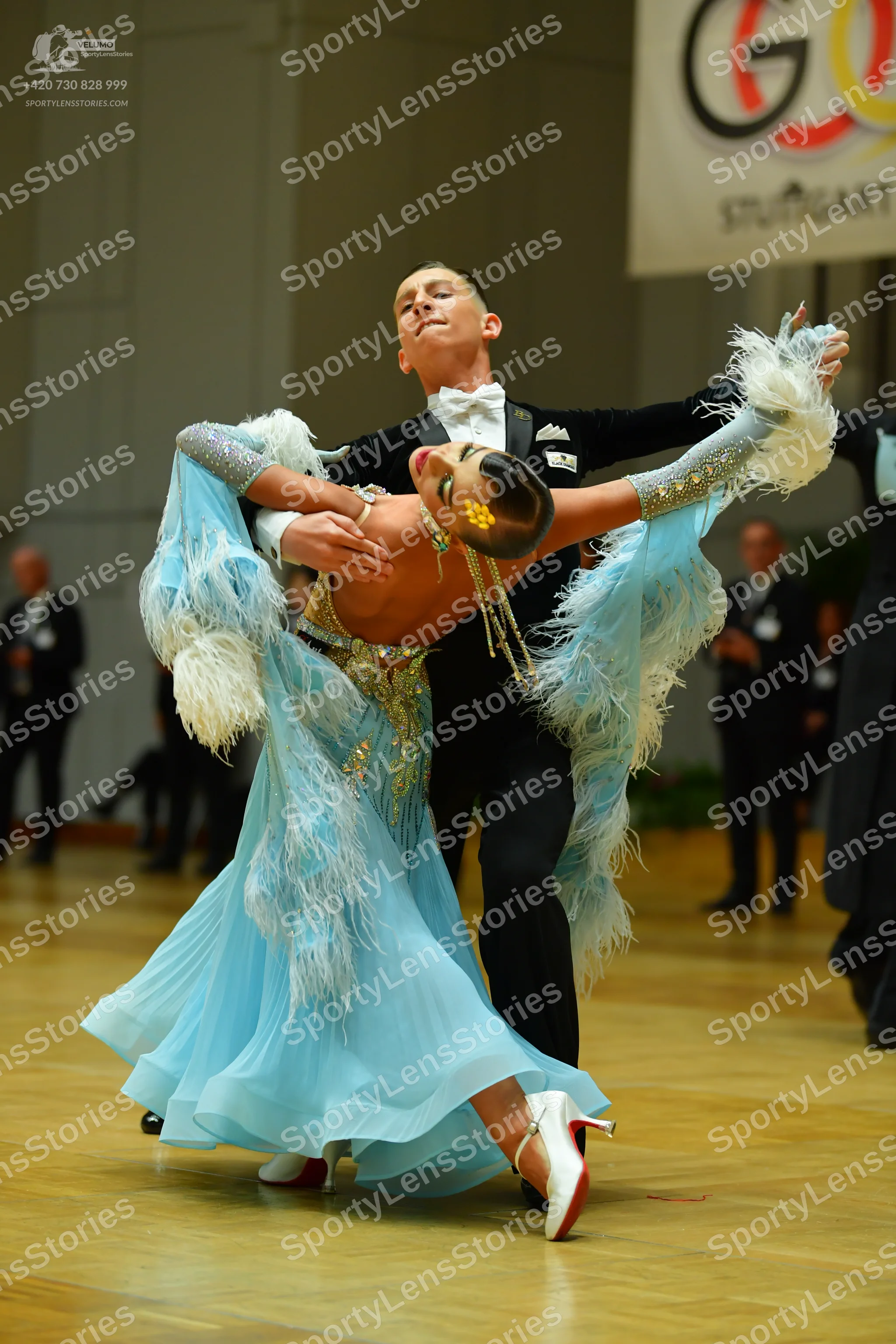 Dancesport competitor: Male dancer: black suit, white shirt, and white bow tie