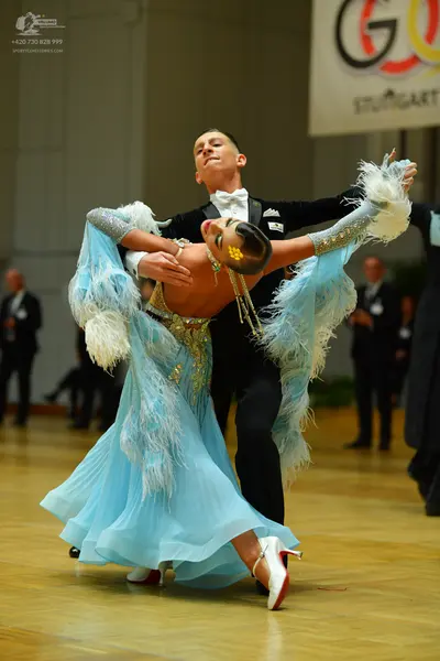 Dancesport competitor: Male dancer: black suit, white shirt, and white bow tie