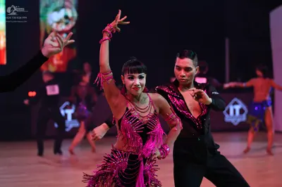 Dancesport competitor: Male dancer: black dance shirt with pink/magenta sequin embellishments on the ch