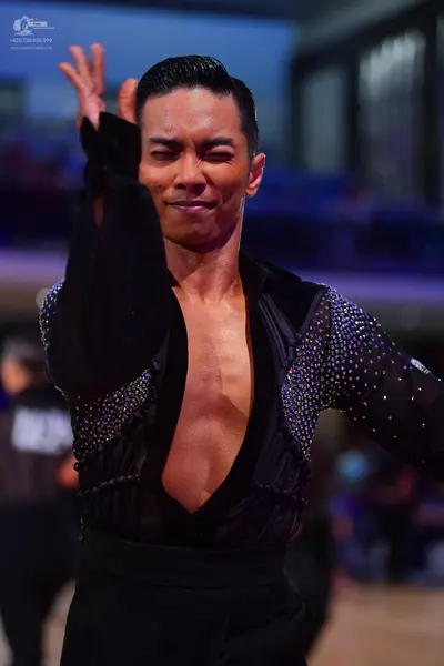 Dancesport competitor: Male dancer: black long-sleeved shirt with silver sequins on the chest and sleev