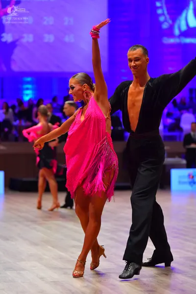 Dancesport competitor: Female dancer: pink latin dress with fringe