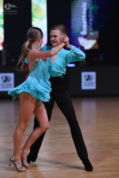 Dancesport competitor: Female dancer: light blue latin dance dress with fringe and thin straps